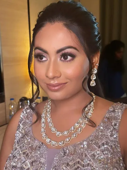 A side profile of this glamorous reception makeup, highlighting the defined eyes and elegant updo.