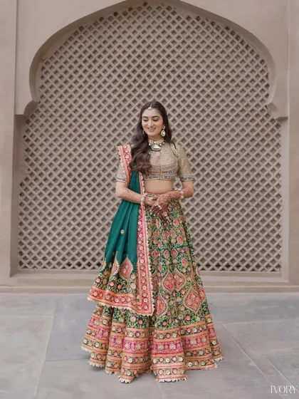 A full-length shot of the bride against a beautiful architectural backdrop.