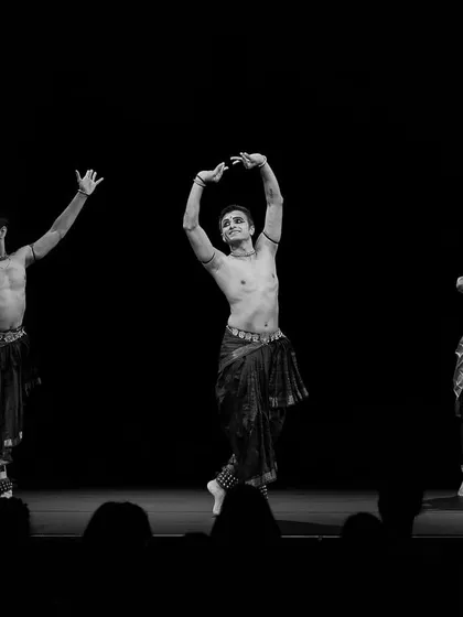 A black and white capture of a dynamic group pose from 'ĀBHA'. This format emphasizes the form, lines, and synchronized energy of our trio.