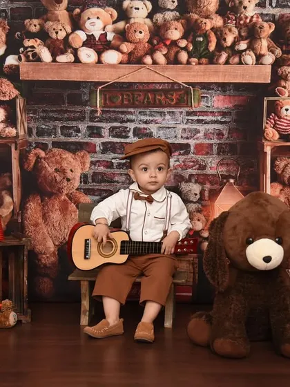 A portrait of a little boy and his bears. This teddy bear theme is a timeless classic, perfect for celebrating a birthday or just capturing a moment in time.
