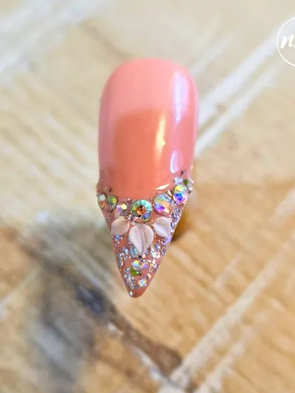 Beautiful stone placement by a student. They've created a sparkling, jeweled tip on a coral base, showing great precision and an eye for design.