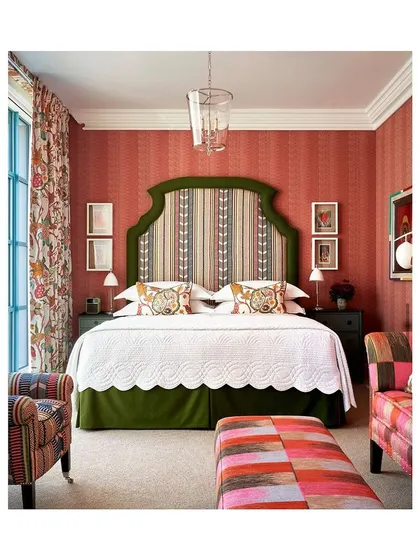 This hotel room is what dreams are made of. The clever play of colours and layering of patterns and textures, from the striped wallpaper to the floral curtains and patchwork furniture, creates a space that is visually stunning.