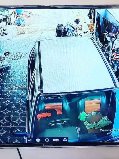 This camera is positioned to monitor a narrow driveway next to a house.