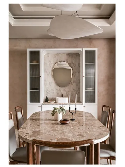 The dining room in Project ASA is a statement in itself. It features a custom dining table with a stunning inlay stone top, a unique sculptural ceiling light, and a built-in crockery unit with a textured tile backsplash.