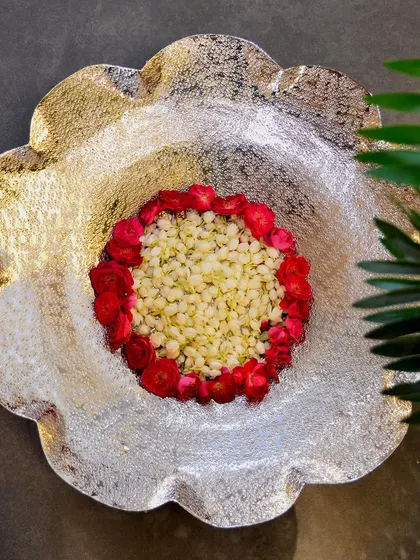 Another beautiful arrangement in our nickel-plated floral thal, this time with jasmine and rose petals. The texture of the thal catches the light beautifully.
