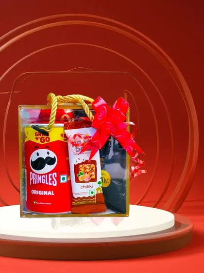 Simple, classic, and always a hit. This hamper features original Pringles and other savory and sweet snacks, finished with a bright red bow. It’s a straightforward and appreciated gift for any occasion.