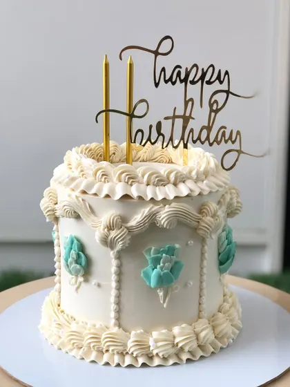 A simple vintage-style cake with white and teal buttercream, perfect for an elegant and understated celebration.