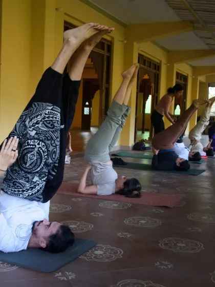 Students exploring inversions like shoulder stand during a retreat. It's inspiring to see everyone challenge themselves and support each other's growth.