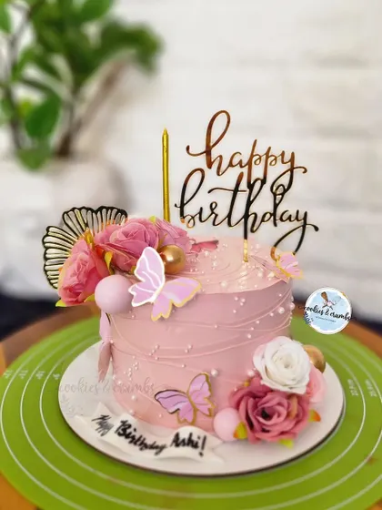 A rosey affair. This pretty pink cake is decorated with a string-pull texture, fresh roses, and delicate butterflies for a romantic and feminine birthday.