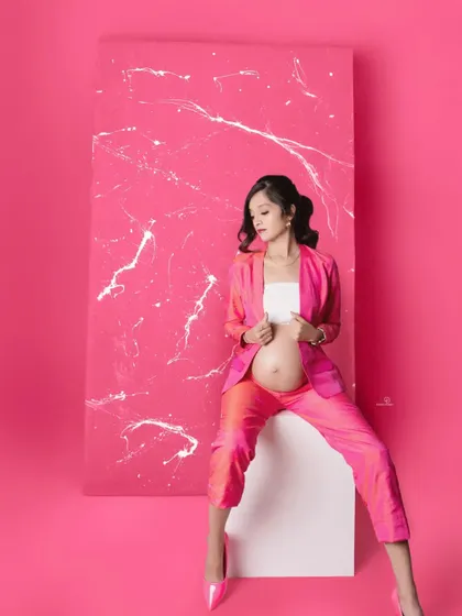 Another take on this fabulous pink suit look. The combination of the modern outfit and the artistic backdrop creates a truly unique and stylish maternity photo.