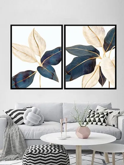 A beautiful set of two framed prints featuring sleek banana leaves in shades of deep blue and cream. The elegant, flowing lines and sophisticated color palette add a touch of luxury to any room.
