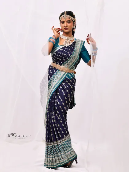 A full-length shot from a creative photoshoot. This look combines a traditional navy blue saree with modern styling, including sheer gloves and elegant jewelry, showcasing my versatility.