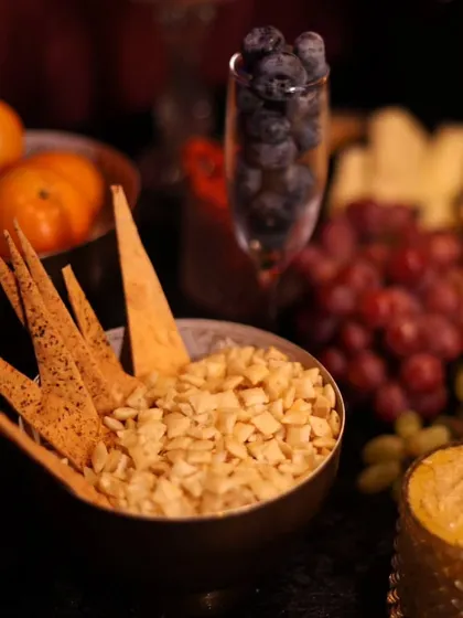 A close-up of some of the snacks from a grazing table, including crispy crackers and nuts. These are perfect accompaniments for our beverage service.