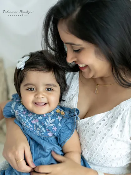 A duplicate of image 9, a beautiful close-up of a mother and her smiling baby. The focus is entirely on their faces and the joy they share.