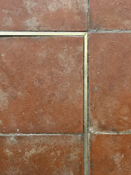 The flooring at Eka features a subtle brass inlay within the terracotta tiles. This detail adds a touch of refinement and quietly guides the customer's journey through the space, reflecting our focus on small, meaningful design gestures.