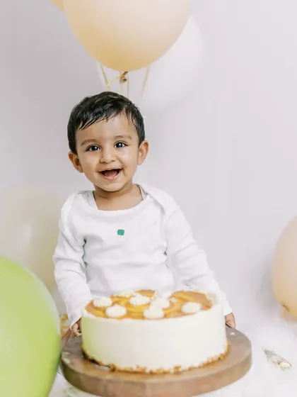 A happy smile before the cake arrives. My at-home birthday sessions are designed to be relaxed, ensuring your baby is comfortable and happy throughout the shoot.