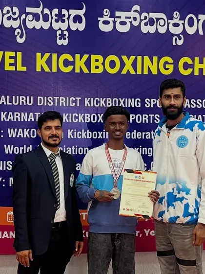 Presenting a silver medal to one of my kickboxers at the state championship. Every win is a team win.