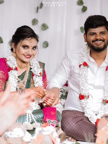 Another view of the engagement ceremony, capturing the moment from a guest's perspective, showing the hands of family clapping in the foreground.