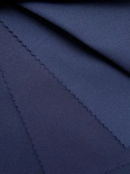 The rich texture and color of our navy wool fabric. This is a perfect choice for a classic blazer or a full suit that exudes authority and style.