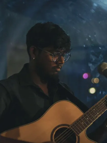 A guitarist setting a soulful mood with the city lights as his backdrop. It's these moments of musical connection that make our space so special.