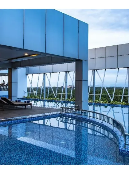 The rooftop swimming pool at the luxury hotel in Calicut. The design provides guests with a relaxing escape, featuring an infinity edge pool with stunning views of the surrounding area.