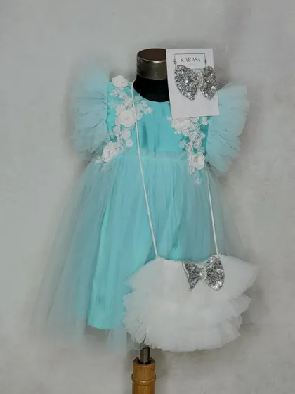 The perfect gift for a loved one's first birthday. Our "Alia" dress in aqua comes with a matching ruffled bag and sequin bow, all beautifully packed in our gift box.