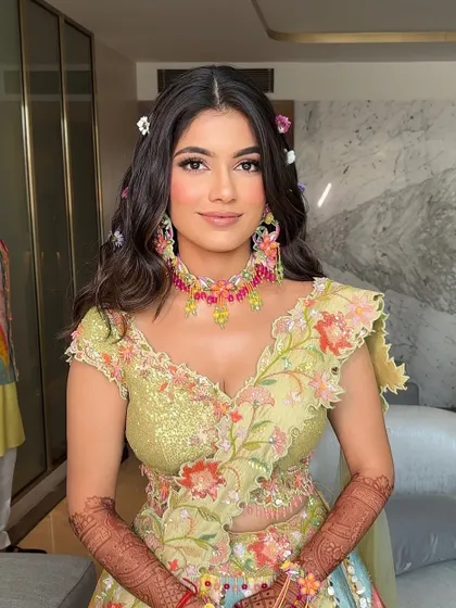 A fresh and romantic look for a Mehendi, with soft open waves and tiny flowers scattered throughout the hair.