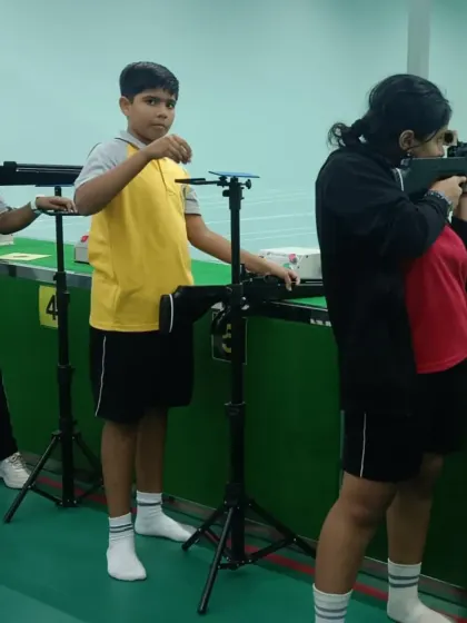 A young athlete receives guidance on her stance. Proper technique is fundamental, and our coaches provide personalized attention to ensure every student develops a solid base.