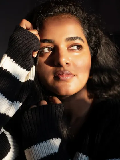 A beautiful golden hour portrait of a makeup artist. The warm light hitting her face highlights her features and creates a soft, glowing effect.