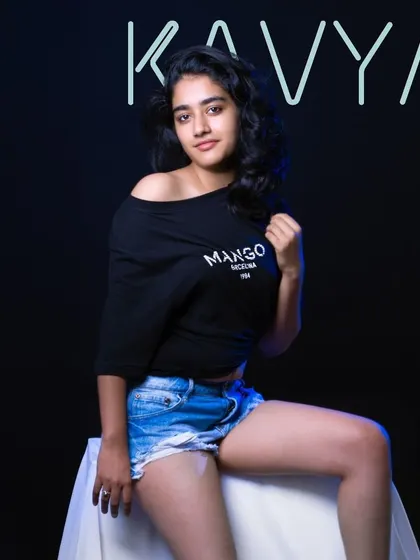 A relaxed and confident studio portrait with a modern neon sign. This setup is great for a contemporary and casual model portfolio.