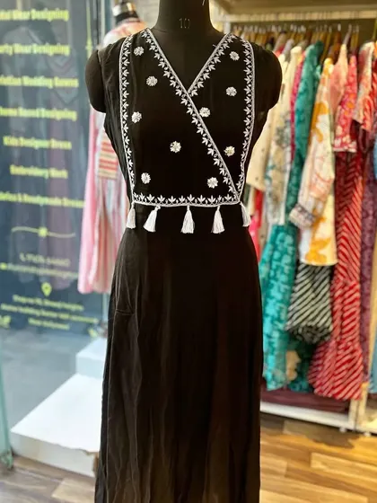 A custom embroidered black kurta with a stylish wrap-around design and tassel details. It's a chic and modern take on the classic kurta.