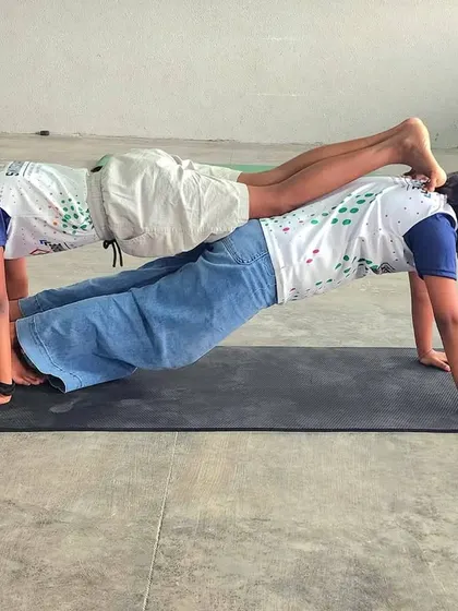 A double plank pose demonstrates incredible strength and coordination. Our dry-land sessions focus on building a strong foundation for powerful swimming.