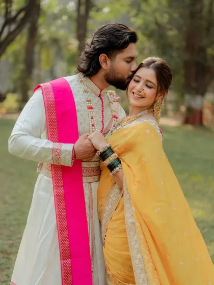 A tender moment between the couple. The bride's makeup is soft and romantic, perfect for these intimate, candid shots. Her happiness truly makes the look complete.