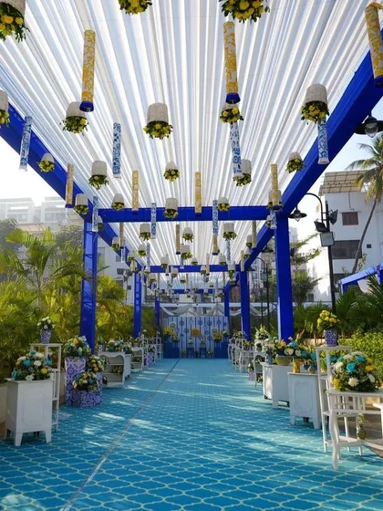 A wide view of the blue and white themed Haldi walkway, showing the grand scale and cohesive design that transforms the venue.