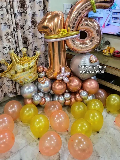 A close-up of the 16th birthday balloon bouquet, featuring a large crown foil balloon.