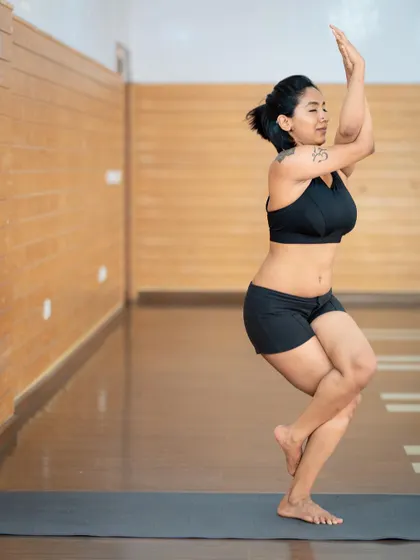 Twisting into Garudasana, or Eagle Pose. This posture is amazing for improving focus and balance while stretching the shoulders and upper back. It’s like giving yourself a big, twisted hug.