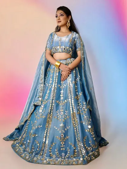 A full-length view of the look taught in my pro course. Students learn how to create makeup that complements grand outfits like this embroidered blue lehenga.
