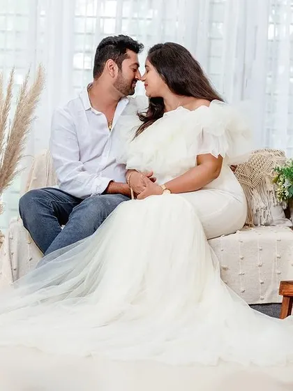 An intimate moment between a couple in our bright, bohemian-style studio setup. The white gown and natural-fiber props create a clean, airy, and romantic feel.