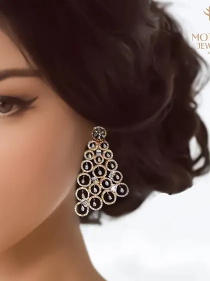 A model showcasing a pair of dramatic chandelier earrings with a cascading circle design. These are statement pieces designed for maximum glamour and impact.