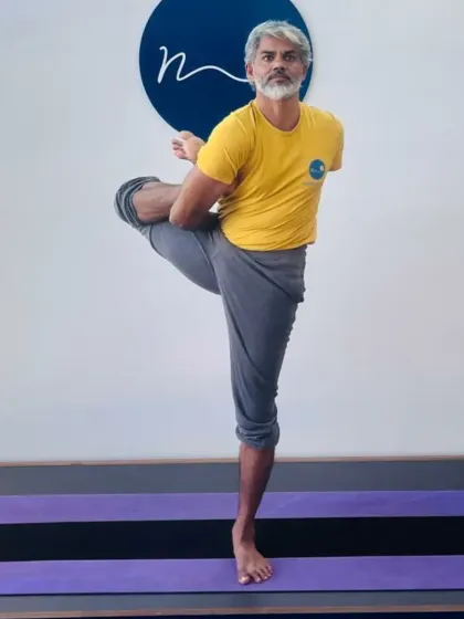 This standing hip-opening posture is a preparation for more complex poses like the leg-behind-head series. It requires balance and deep hip flexion, which we cultivate progressively in our classes.