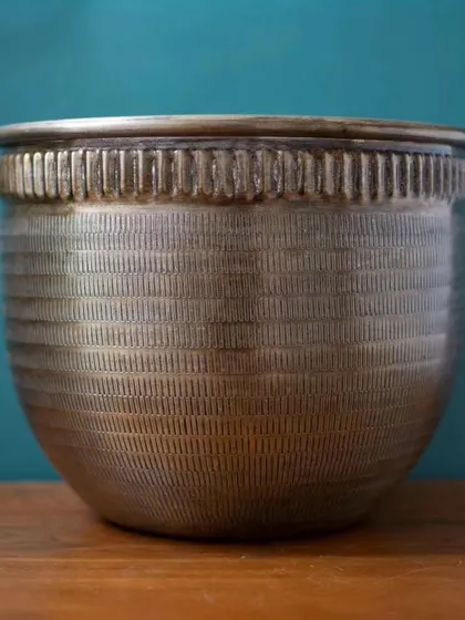 The Baraaz Bronze Finish Planter, shown here in its entirety. Its classic shape and detailed texture make it a versatile piece that complements both traditional and modern interiors.