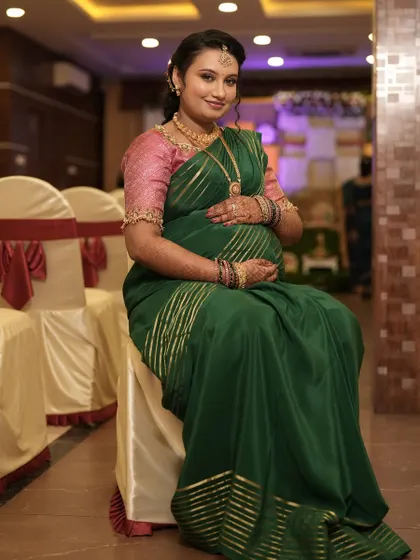 A candid shot from the baby shower event. The makeup is designed to be long-lasting and photogenic, ensuring she looks her best throughout the entire celebration.