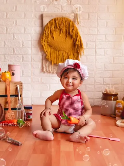 Surrounded by bubbles, this happy little chef is ready for a fun and messy cooking adventure.