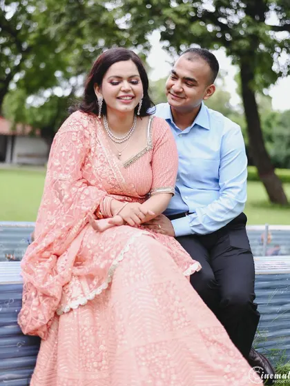 A sweet moment on a park bench. His adoring gaze and her happy, relaxed smile create a portrait that is both simple and full of genuine emotion.
