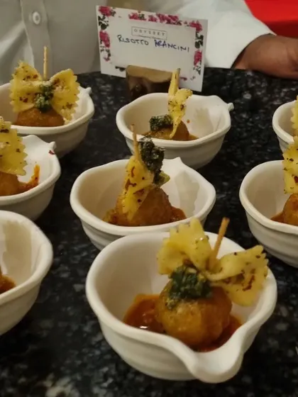 A repeat of our risotto arancini, emphasizing the individual portioning in elegant ceramic bowls. This style of service is ideal for formal events where presentation is key.