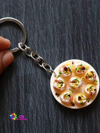 A cute handmade dahi puri miniature keychain, a perfect tiny replica of the popular street food.