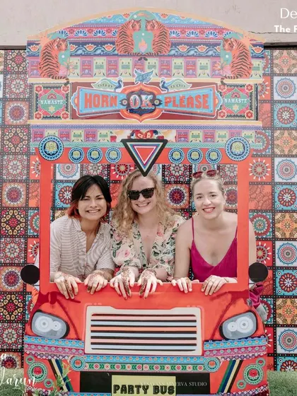 All aboard the party bus! We designed this quirky and colorful "Horn OK Please" photo booth for a Mehendi party, providing a fun and memorable spot for guests to snap pictures.