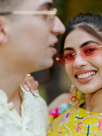 A close-up of this fun pool party look. The pink-tinted sunglasses and bold earrings are the perfect accessories for her colorful outfit and my fresh, sun-kissed makeup.