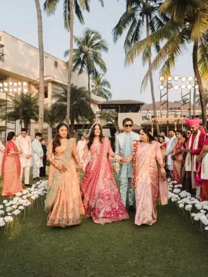 The bride walks down the aisle, flanked by the women of her family. This powerful image showcases the strength and support of family on her big day.