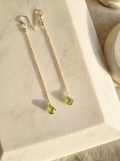 A simple, elegant shot of my Peridot drop earrings. This stone enhances confidence and motivates growth and change.